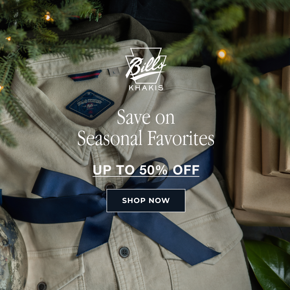 A Bills khakis shirt sits folded with a navy bow under a tree
