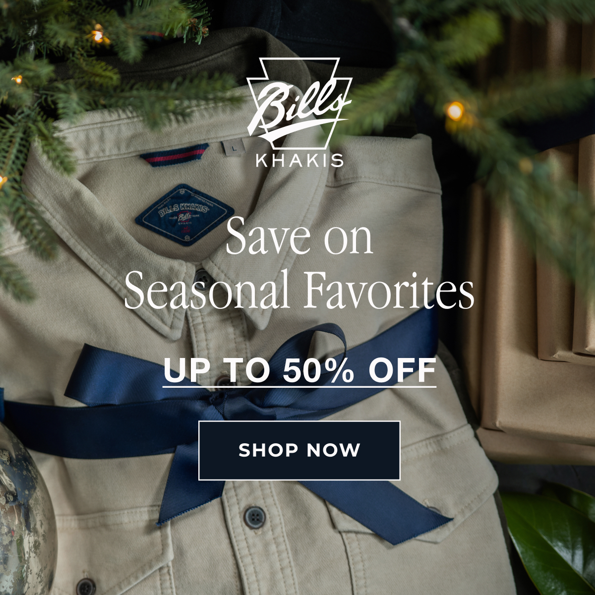 A Bills khakis shirt sits folded with a navy bow under a tree