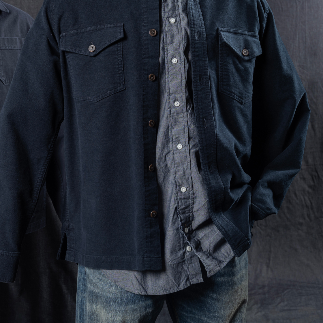A mannequin wears Bills Khakis denim pants, a navy overshirt and faded blue standard fit shirt