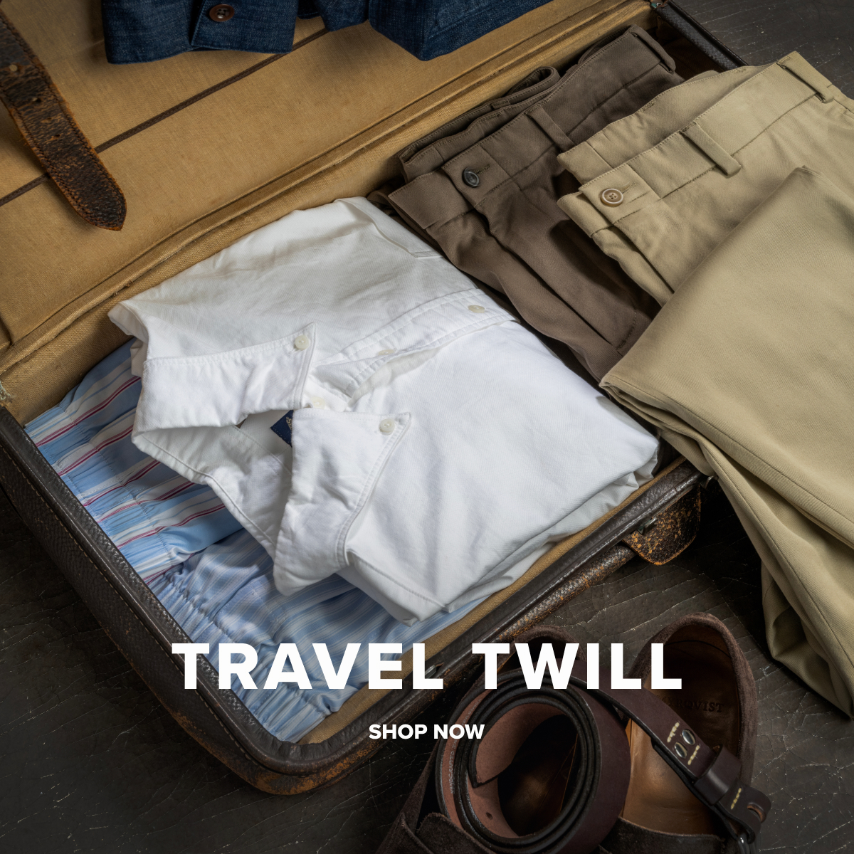 An array of Bills Khakis tops, pants and boxers in travel twill fabrics sit in a vintage suitcase