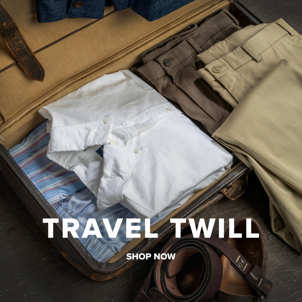 An array of Bills Khakis tops, pants and boxers in travel twill fabrics sit in a vintage suitcase