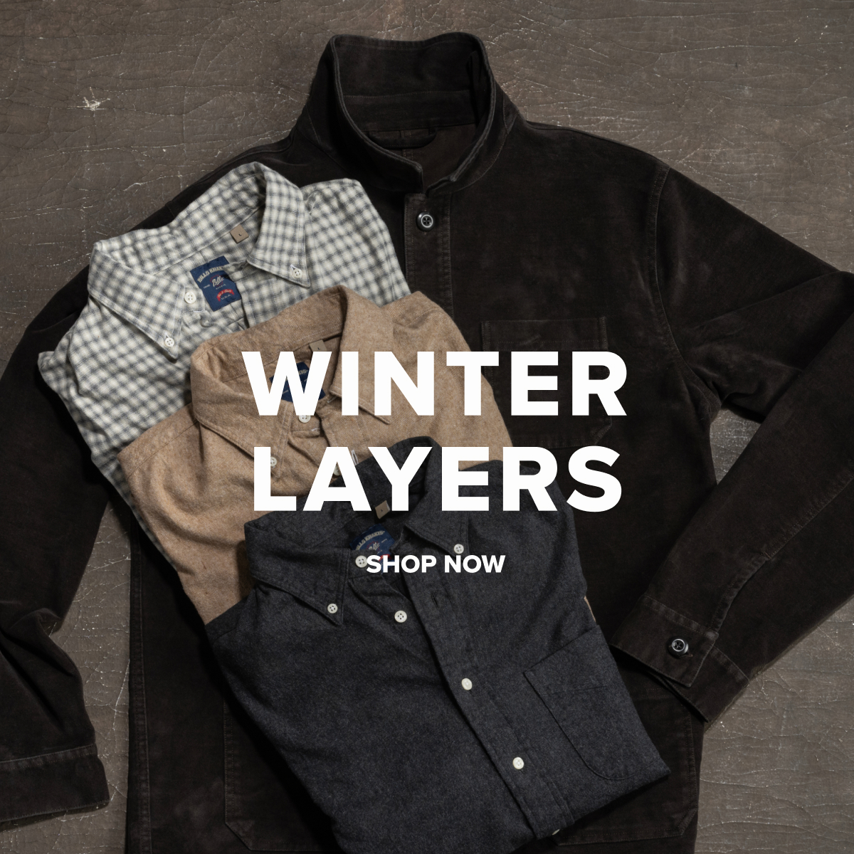 A Bills Khakis Washed Moleskin Chore Jacket lays on an industrial brown surface with multiple Bills Khakis Flannel Shirts