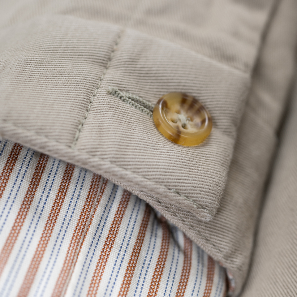 A close up of the waste button area of Bills Khakis Vintage Twill pants. 