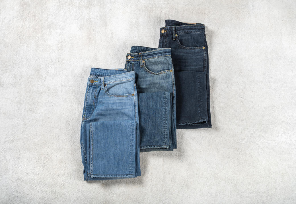 A photo of three shades of Bills khakis Vintage Wash Denim laying on a neutral colored surface