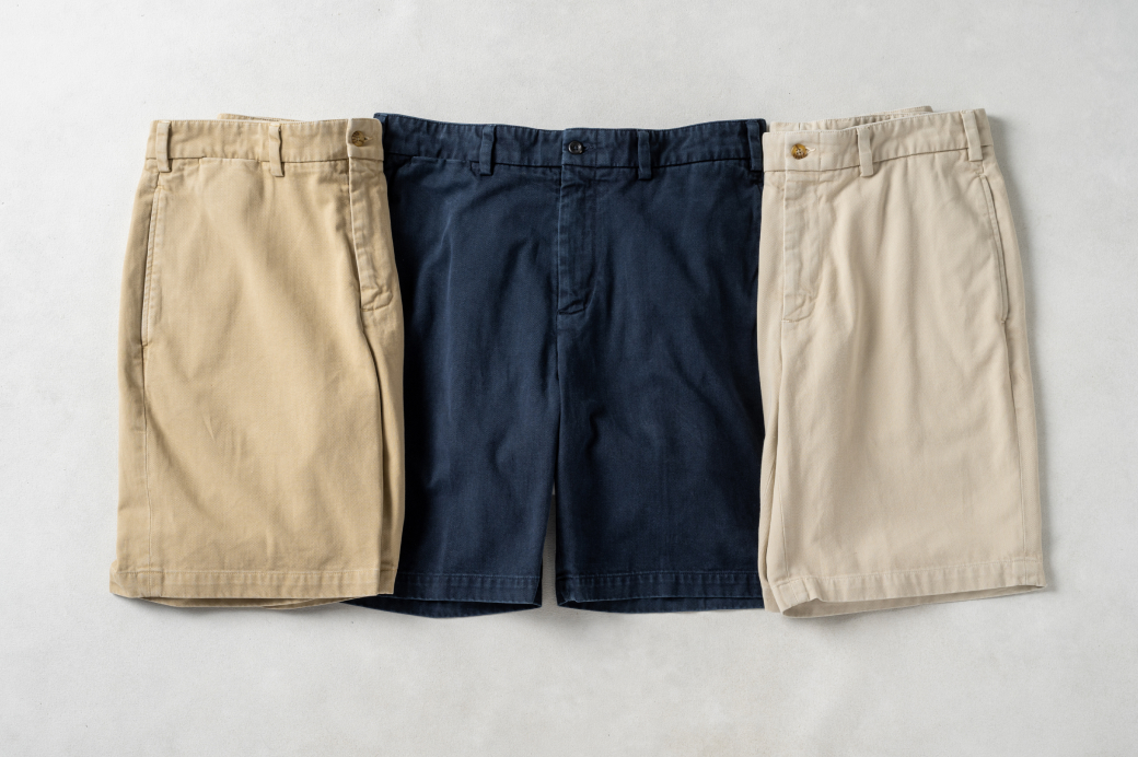 Three pairs of Bills Khakis Heritage Wash Original Twil Shorts laying on a light colored surface