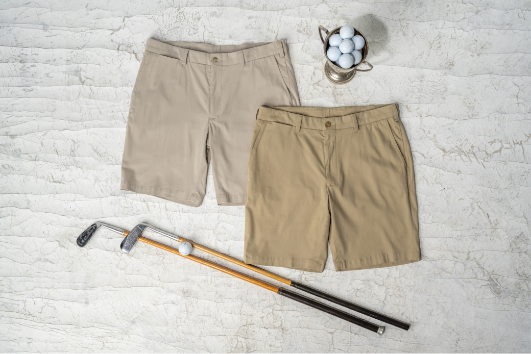 Two Bills Khakis Performance Travel Twill shorts surrounded by vintage golf memorabilia