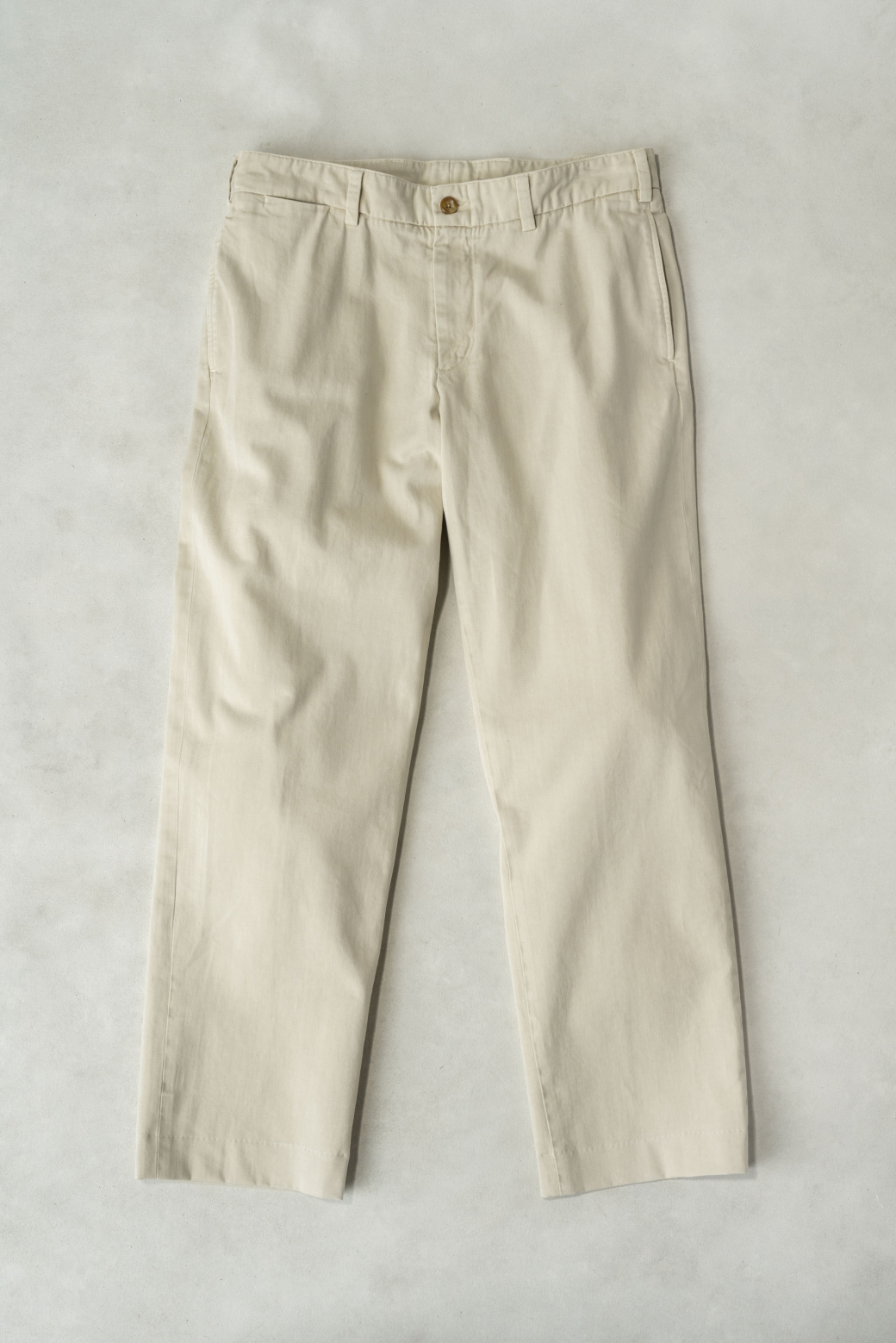 A full laydown shot of Bills Khakis Heritage Wash pants in the new Bone colorway