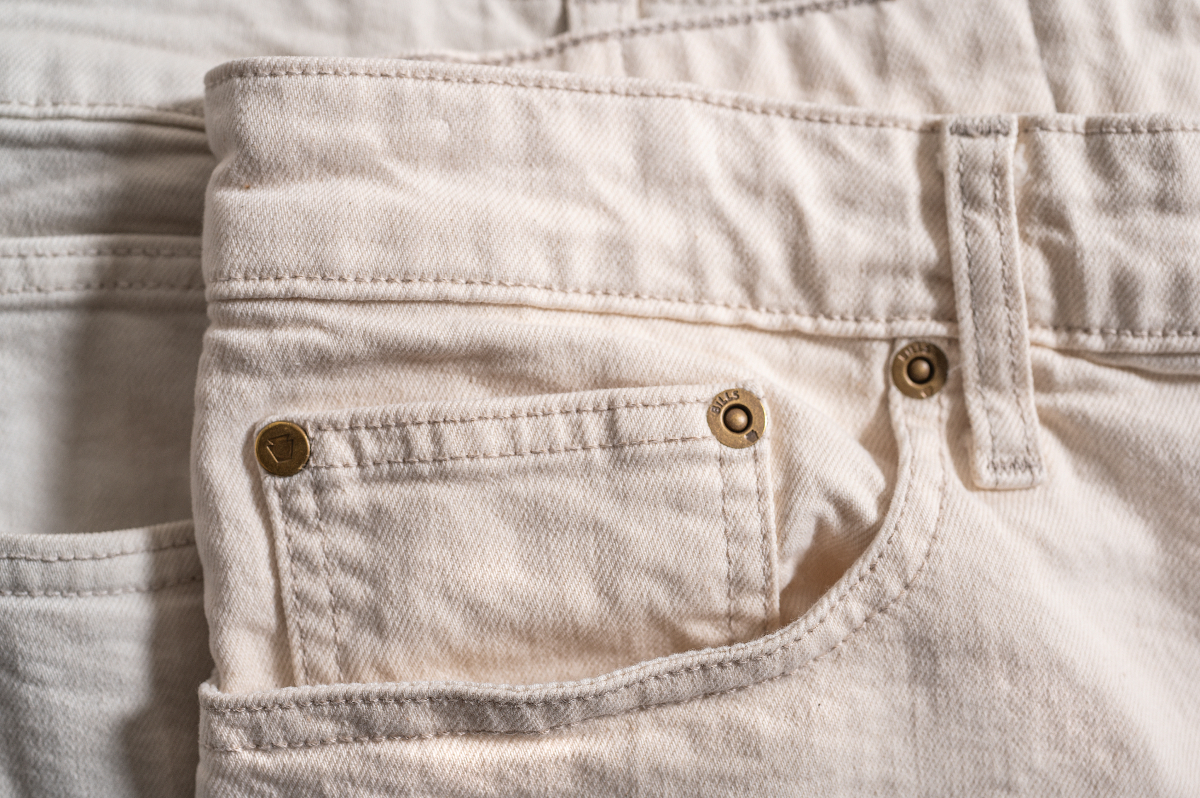 Detail of the pocket area of a pair of Bills Khakis Bullard Twill in bone color