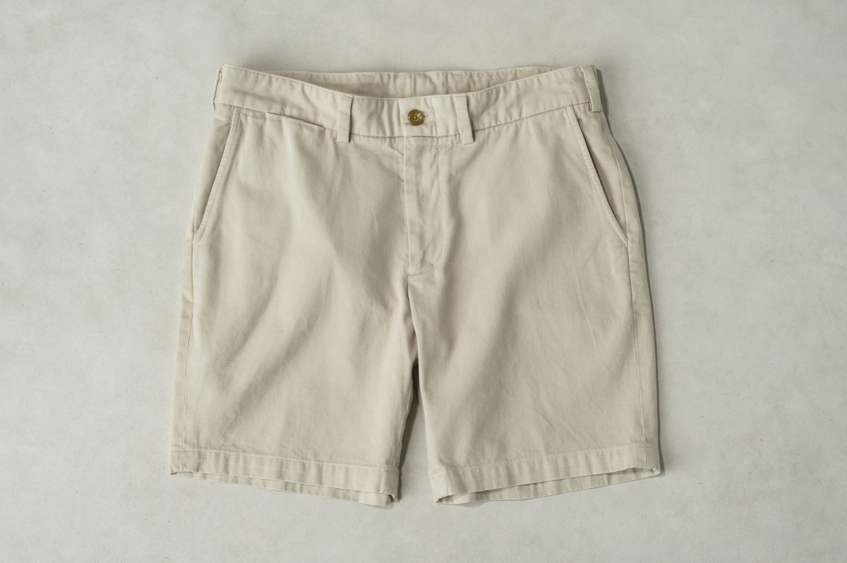 Bills Khakis Khaki shorts laying on a warm stone surface