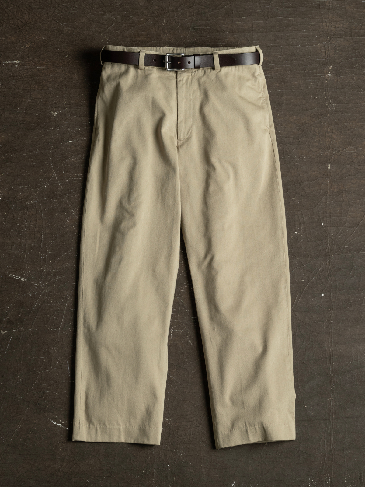 A full image of Bills Khakis M1 Original Twill Khakis laying on an industrial surface