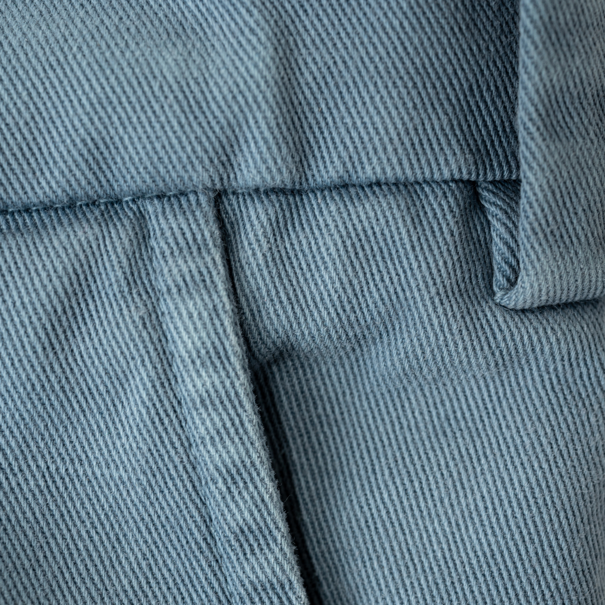 Details of the belt loops and side pocket seam of Bills Khakis Dusty Blue Heritage Wash Shorts