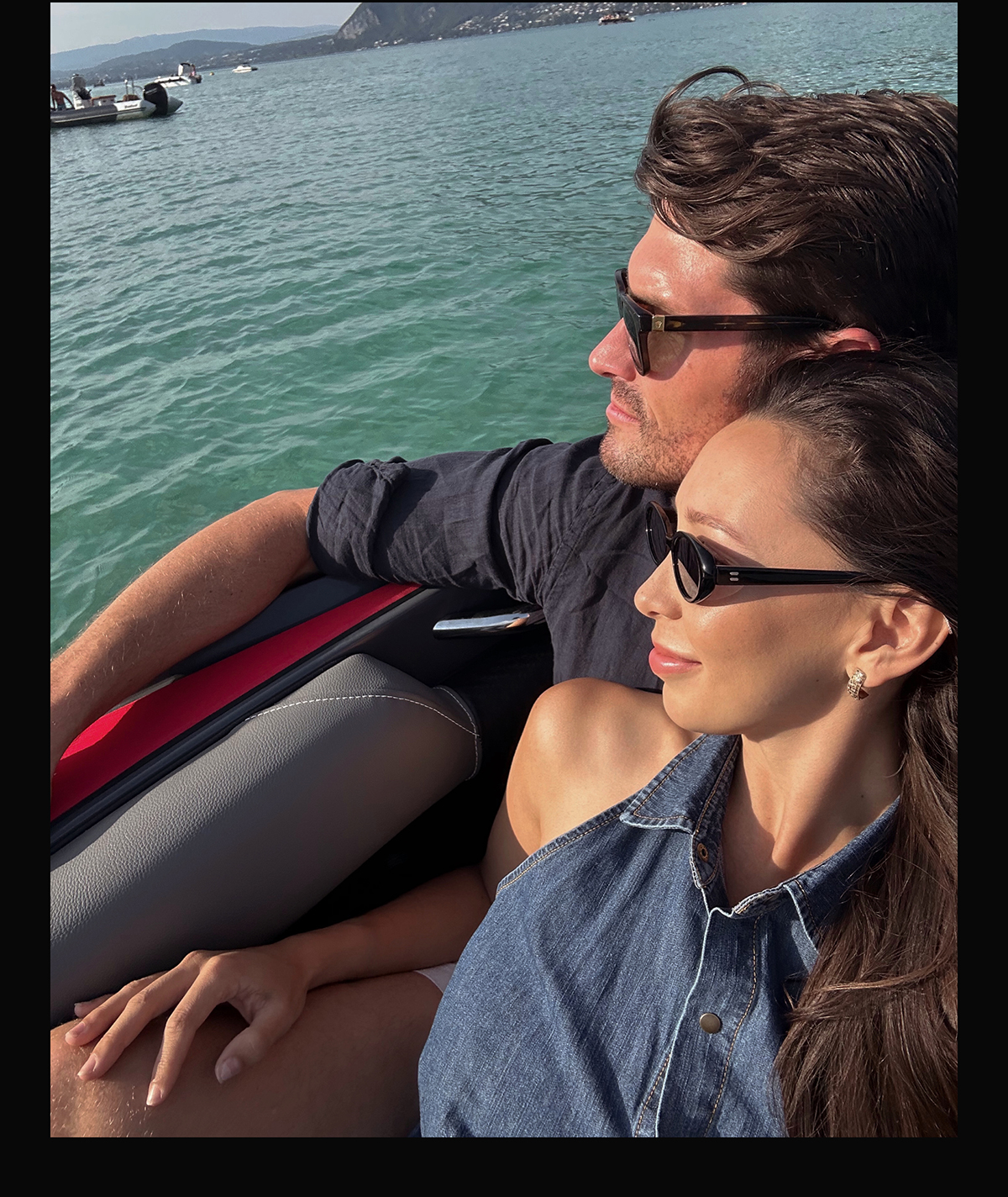 Bennett & Emily in a boat looking over the water