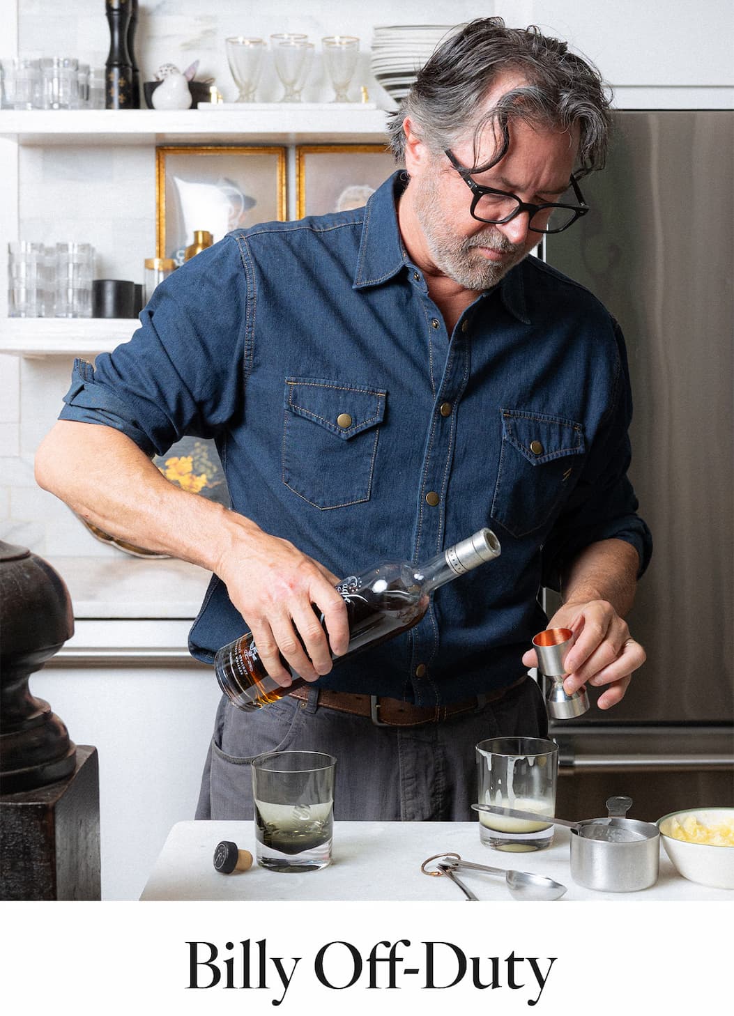 Billy wears the Shoals Denim Shirt in Double Dye as he pours a cocktail.
