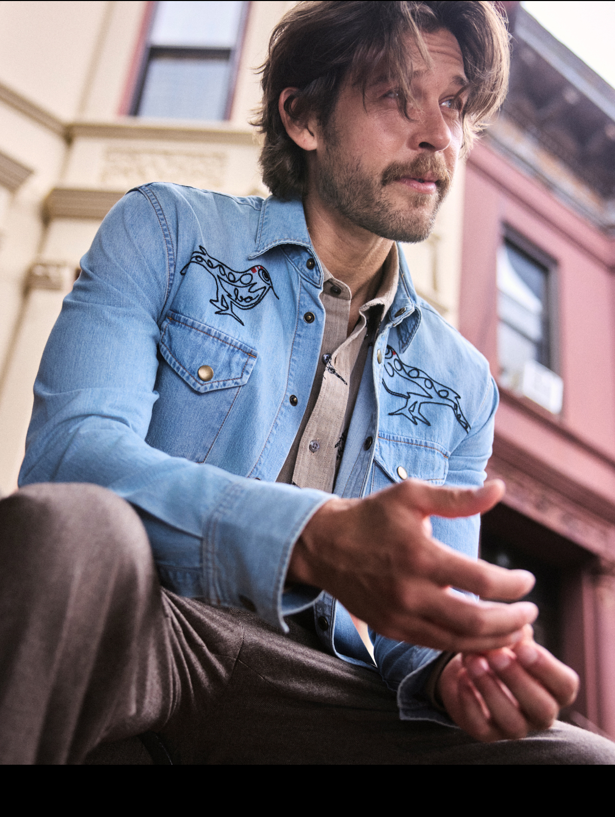 Model wears collab denim shirt.