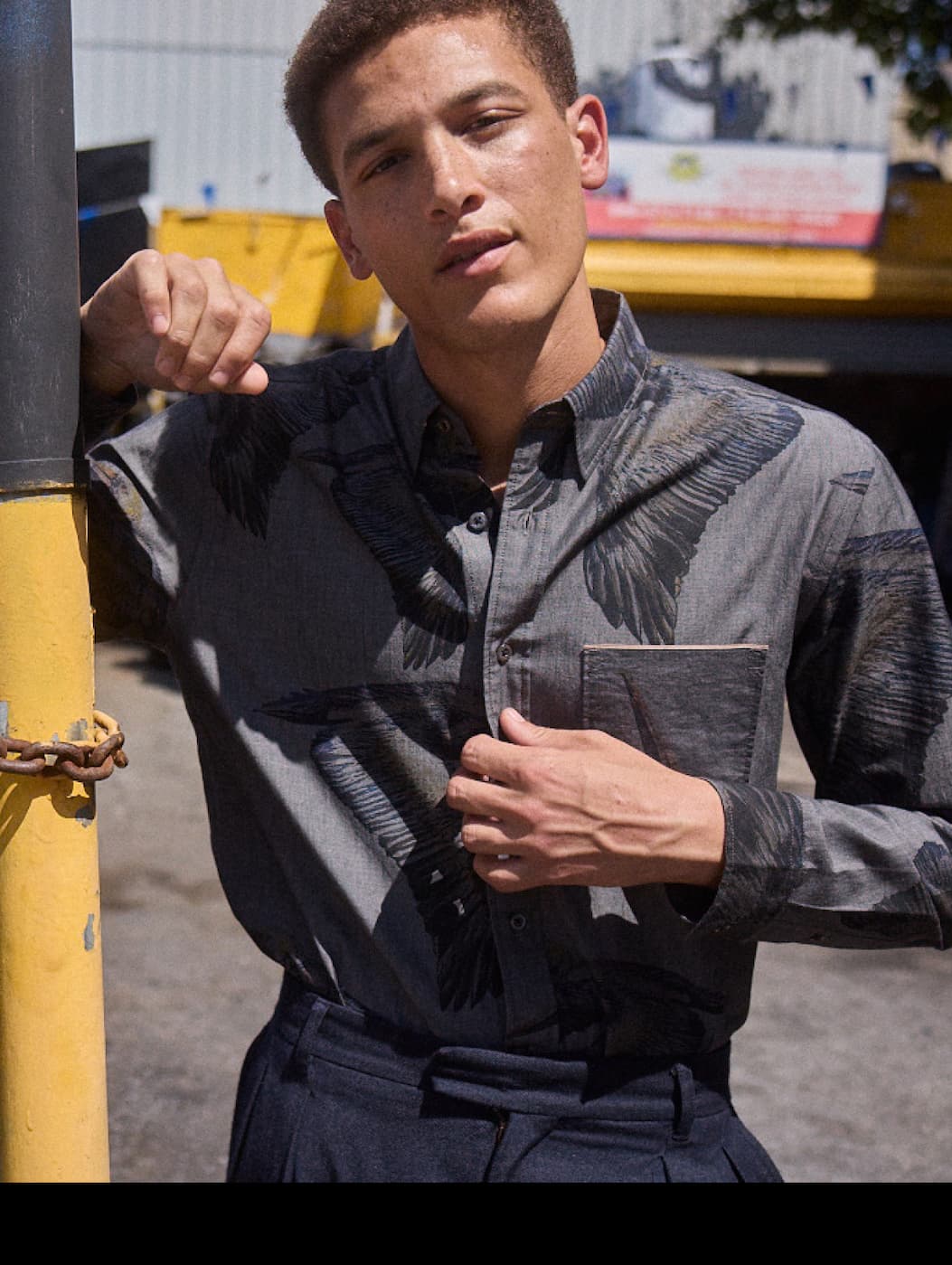 Model wears collab denim shirt.