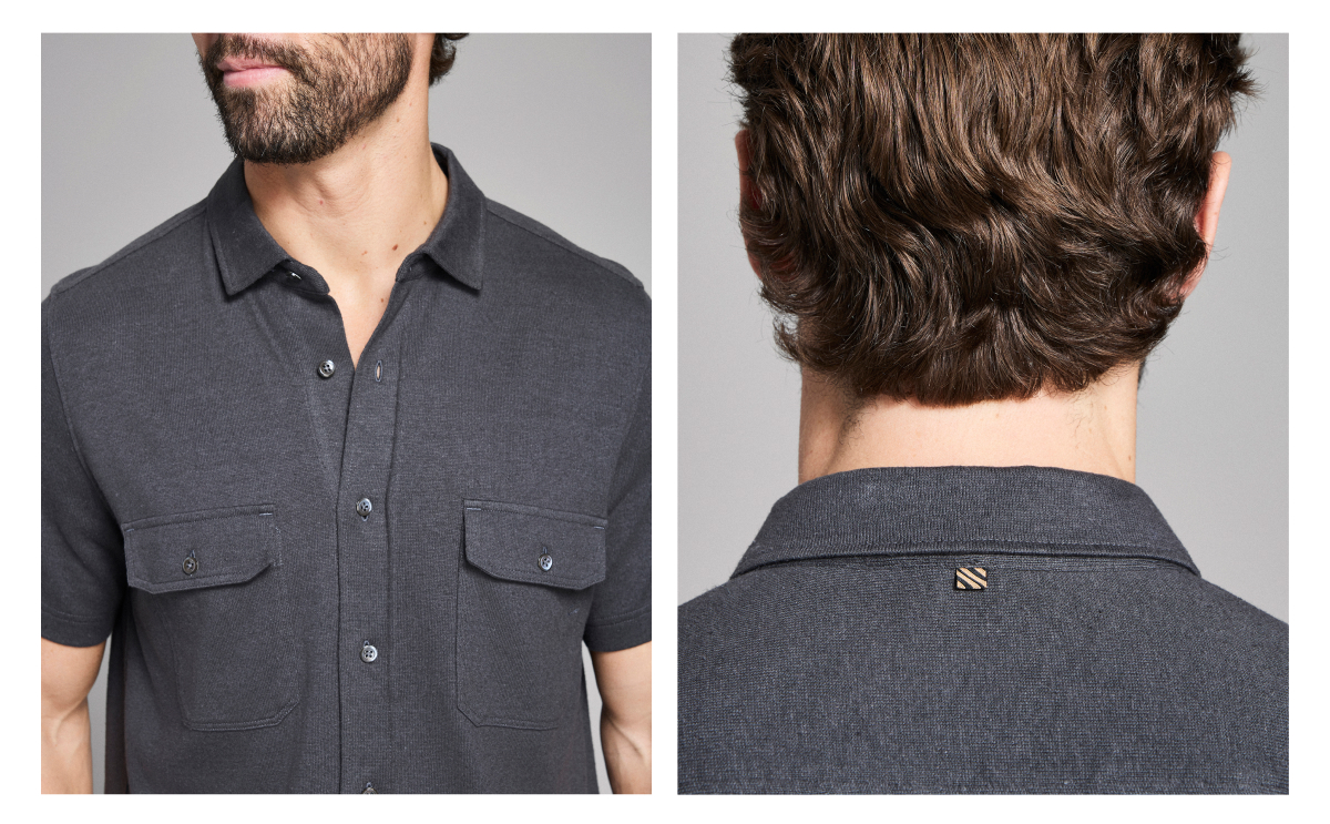 Detail photos of a male model wearing the asphalt color on a grey background. Shows the button down pockets at the chest and a gold and black tag at the back neck.
