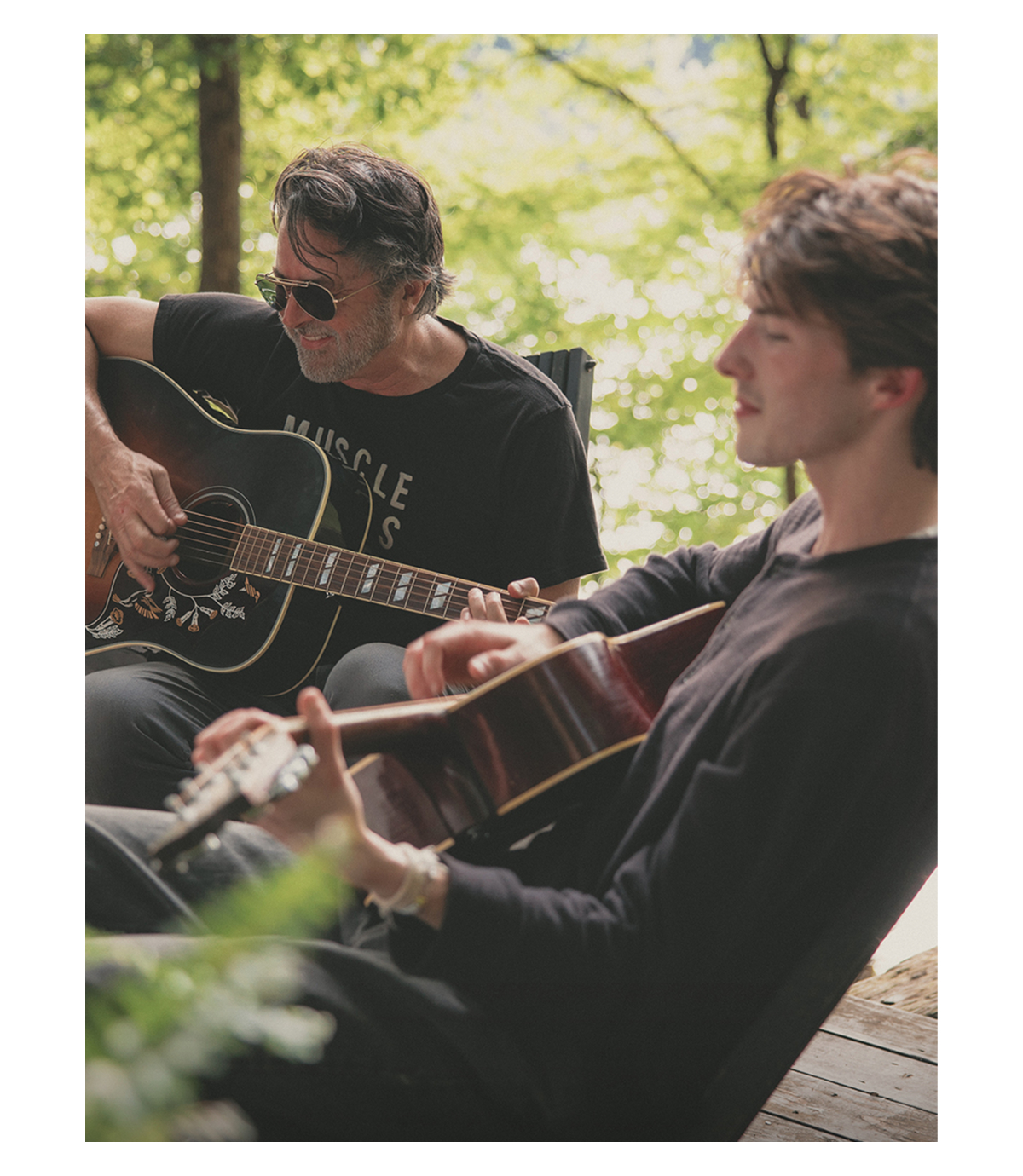 Billy Reid plays guitar with his son, Walt.