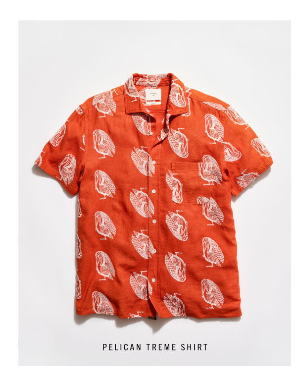The Pelican Treme Shirt: an orange shirt with pelicans embroidered on a grey background.