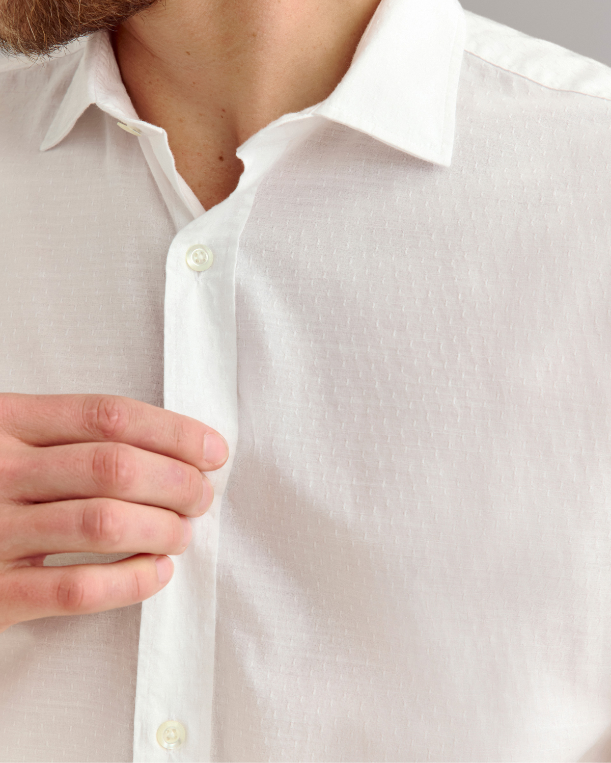 Close up photo of a white shirt with subtle texture.