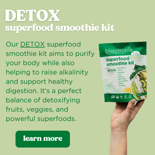 Hand holding a detox smoothie kit over a green background. Text reads: Detox superfood Smoothie Kit. Our DETOX superfood smoothie kit aims to purify your body while also helping to raise alkalinity and support healthy digestion. It’s a perfect balance of detoxifying fruits, veggies, and powerful superfoods. Button Text reads: learn more