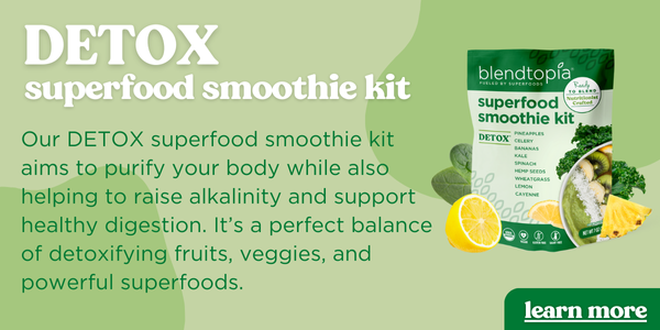 Hand holding a detox smoothie kit over a green background. Text reads: Detox superfood Smoothie Kit. Our DETOX superfood smoothie kit aims to purify your body while also helping to raise alkalinity and support healthy digestion. It’s a perfect balance of detoxifying fruits, veggies, and powerful superfoods. Button Text reads: learn more