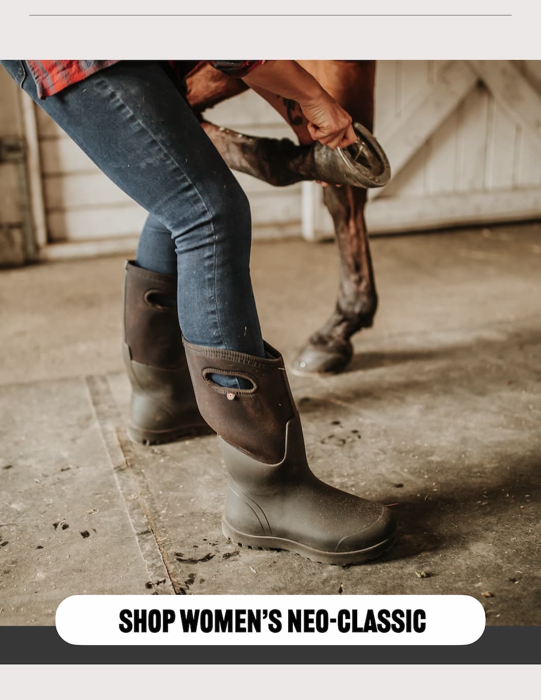 A woman taking off a horseshoe on a horse, wearing our Neo-Classic Tall boots