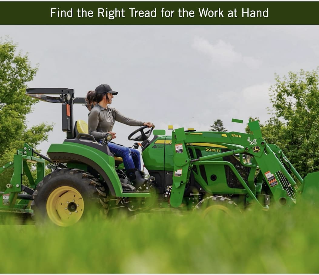 A woman driving a tractor.  Shop our women's farm & work boots.