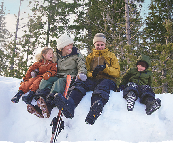 Family hanging out in the snow wearing BOGS boots
