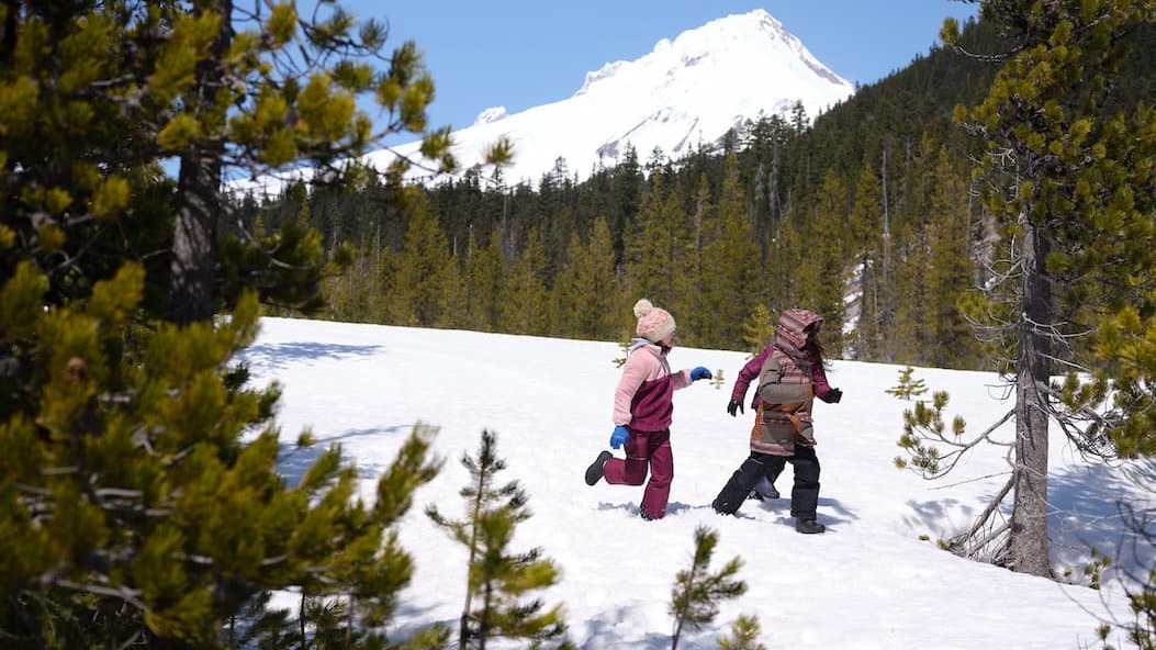 Three kids running through the snow wearing our Kids Classic Seamless boots