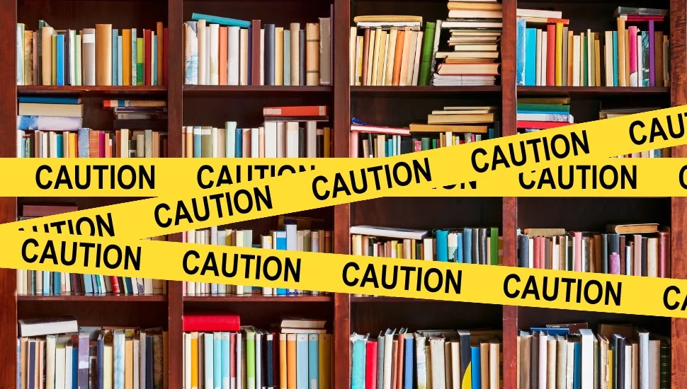 bookshelves with caution tape
