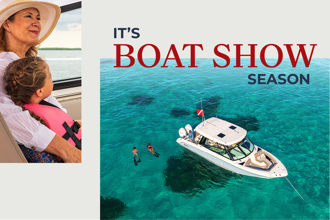 A woman and child on a boat, with a view of a boat anchored in clear blue water with two people snorkeling nearby. Text reads: IT'S BOAT SHOW SEASON.