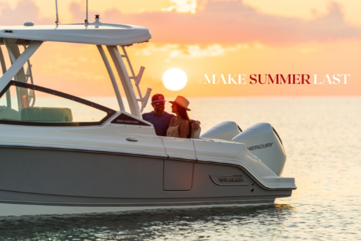 A couple enjoys a serene sunset on a boat, with the words 'MAKE SUMMER LAST' overlaying the golden sky.