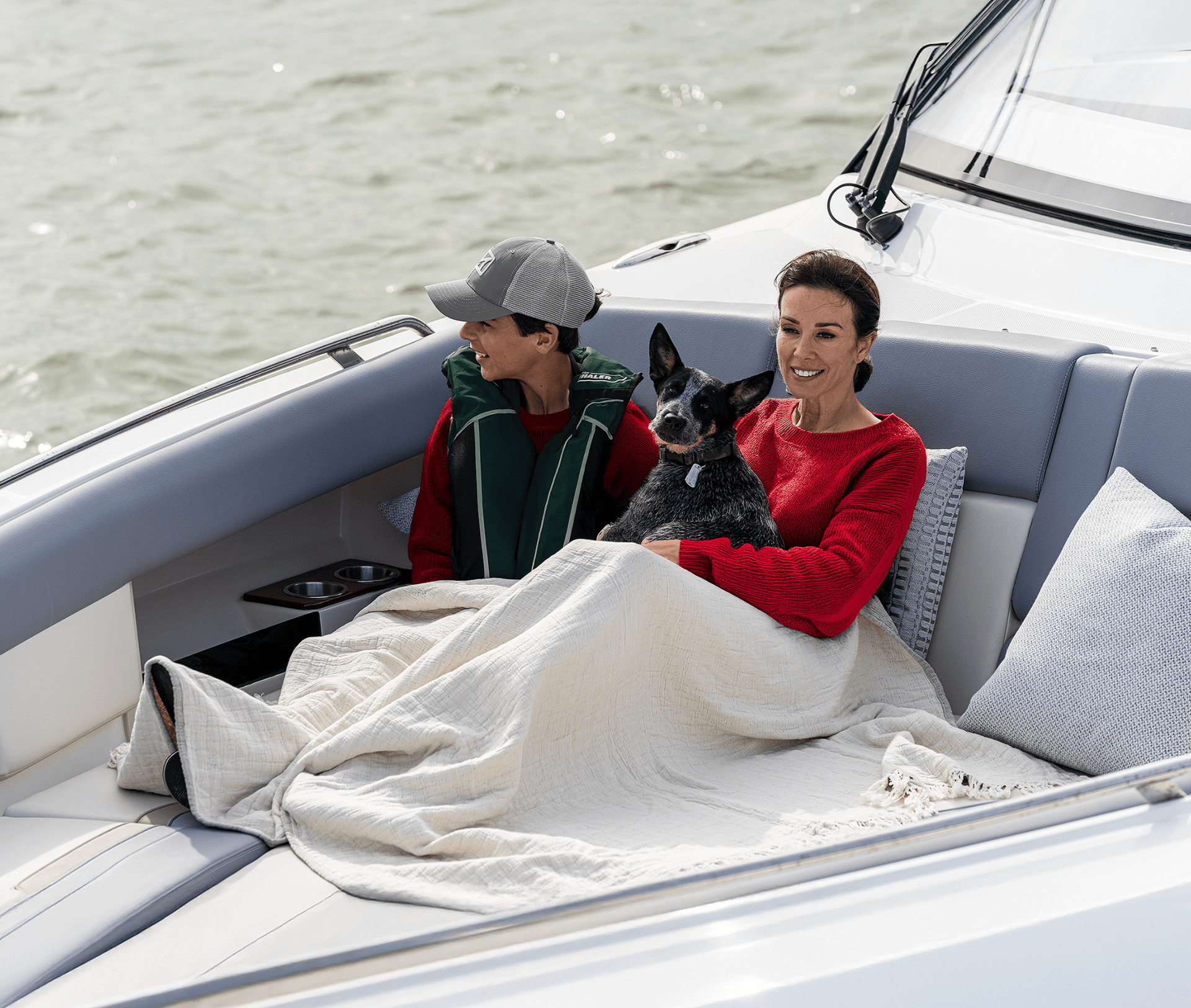 GIF slideshow of people wearing red sweaters and enjoying the cool air on Boston Whaler boats