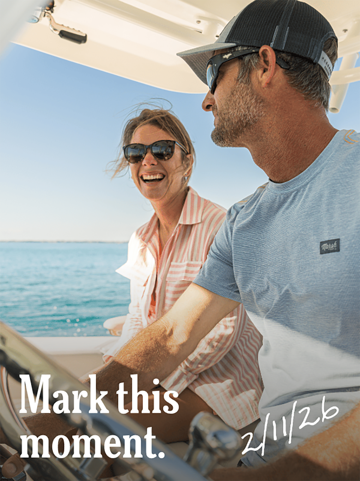 A man and a laughing woman on a boat, with the text 'Mark this moment. 2/11/26'.