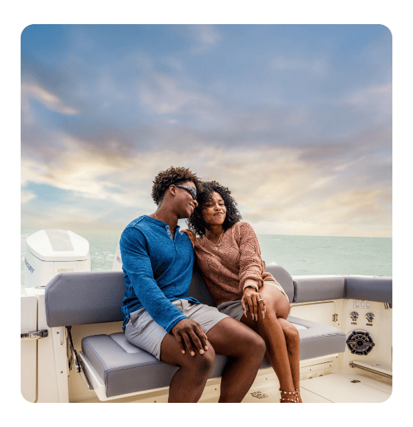 A couple relaxing together at the back of the boat with text overlay saying "Claim your deal"