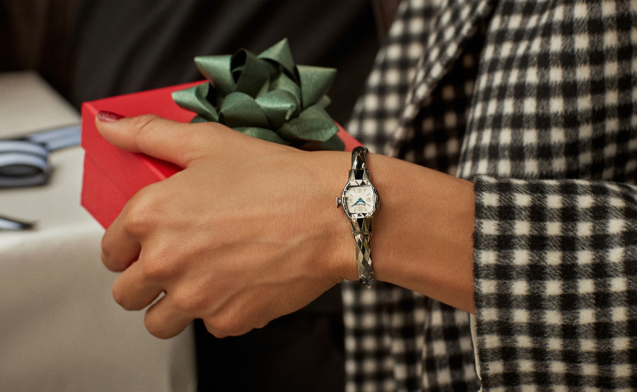 Woman with a giftbox wearing the silver American Girls