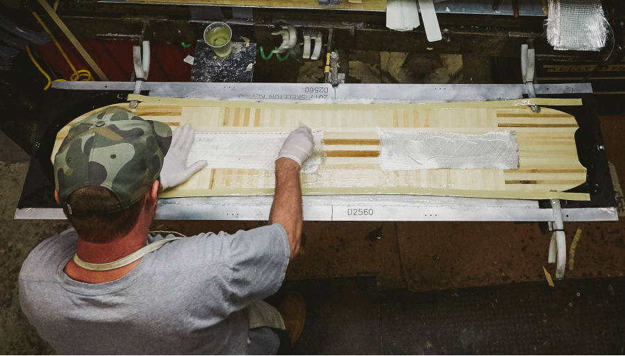 Craig's employee making a Custom Board in the factory