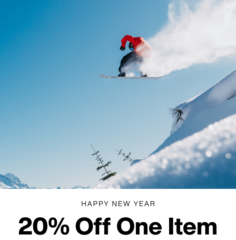 Snowboarder sending it off a kicker in the backcountry with the text 'Happy New Year. 20% Off One Item.'