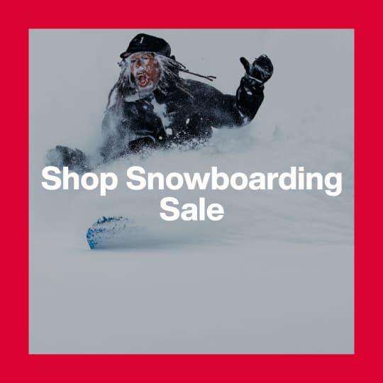 A darkened image of snowboarder riding powder in the background. The text 'Shop Snowboarding Sale' is in white on top.