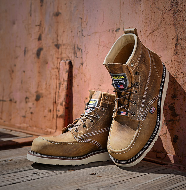 The Amp Usa 6" Steel Toe Work Boot in brown leaning up against the wall. Shop this boot.