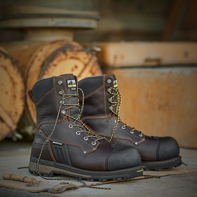 A pair of the Men’s 8” Waterproof Insulated Comp Toe Work Boots in brown sitting on metal. Shop men's sale.