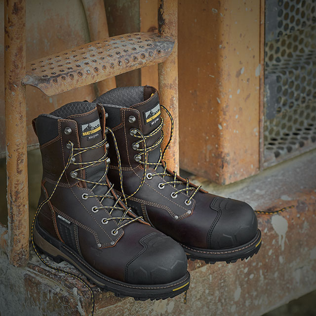 The Men’s 8” Waterproof Insulated Comp Toe Work Boots in brown sitting on metal. Shop sale. 