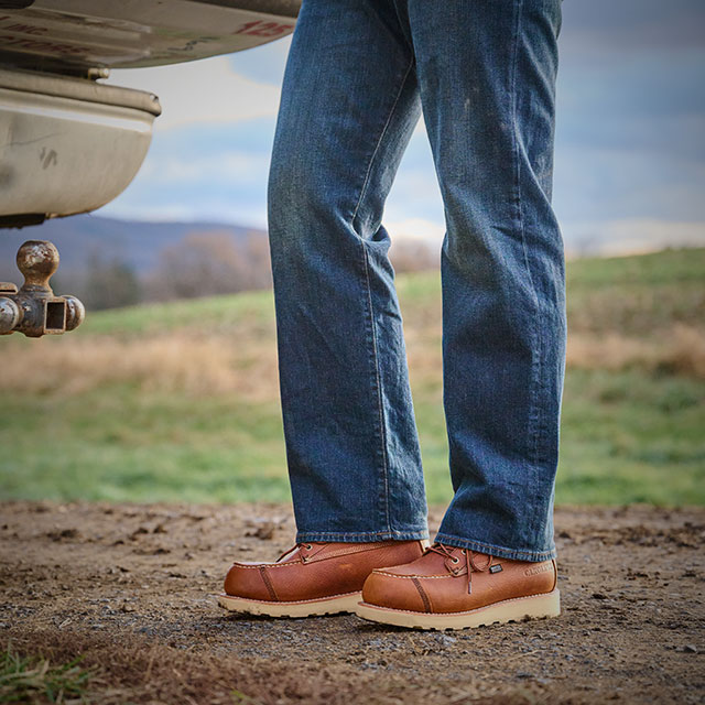 A man wearing the Staple Gun 6" Carbon Comp Toe Work Boot in brown. Shop work wedges for men.