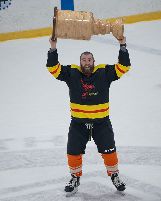 Jackman holding a handmade trophy in his arms on an ice rink. Watch Jackman's video.