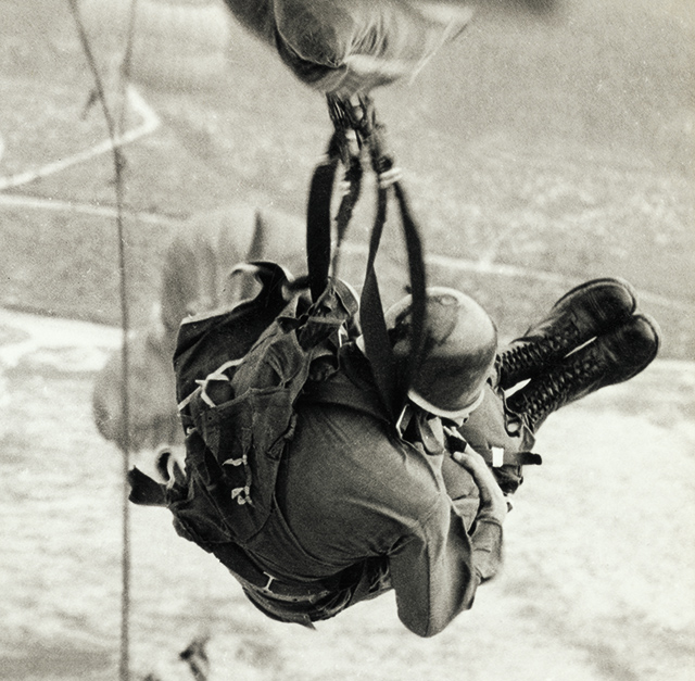 Vintage image of paratrooper jumping out of an airplane.