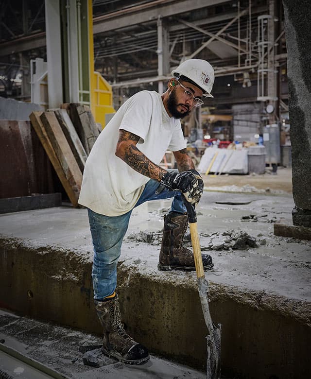 A man wearing the Matterhorn I-Beam boot in brown while working. Shop men's met guard boots.