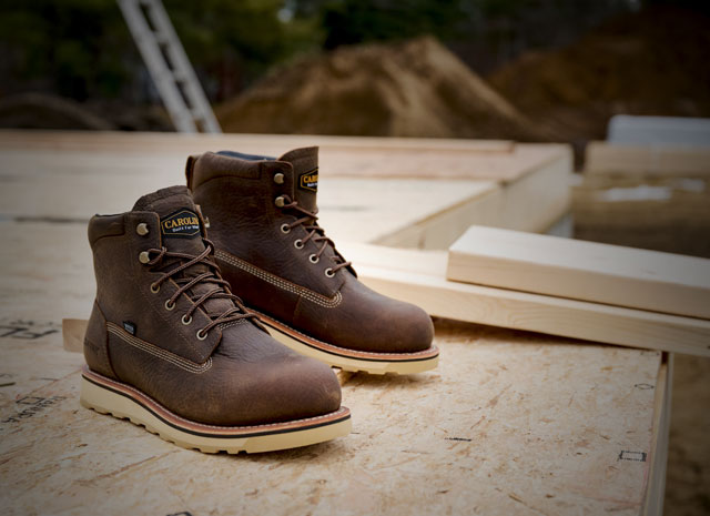 The Staple Gun boots in brown sitting on a table. Shop waterproof sale.  