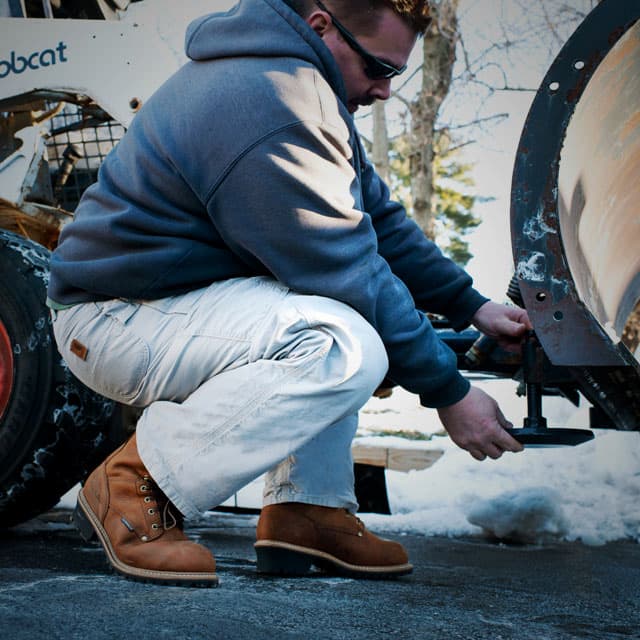 A man working wearing Carolina boots. Shop men's insulated boots.