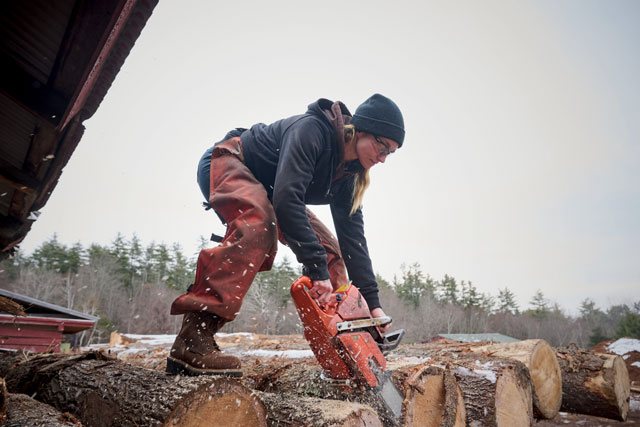 A woman wearing Carolina boots and working. Shop women's.