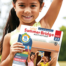 Young girl outside cheering while holding a Summer Bridge Activities grades 2–3 workbook.